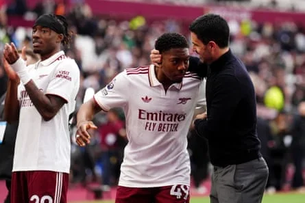 Myles Lewis-Skelly (centre) and Mikel Arteta celebrate after the win over West Ham.